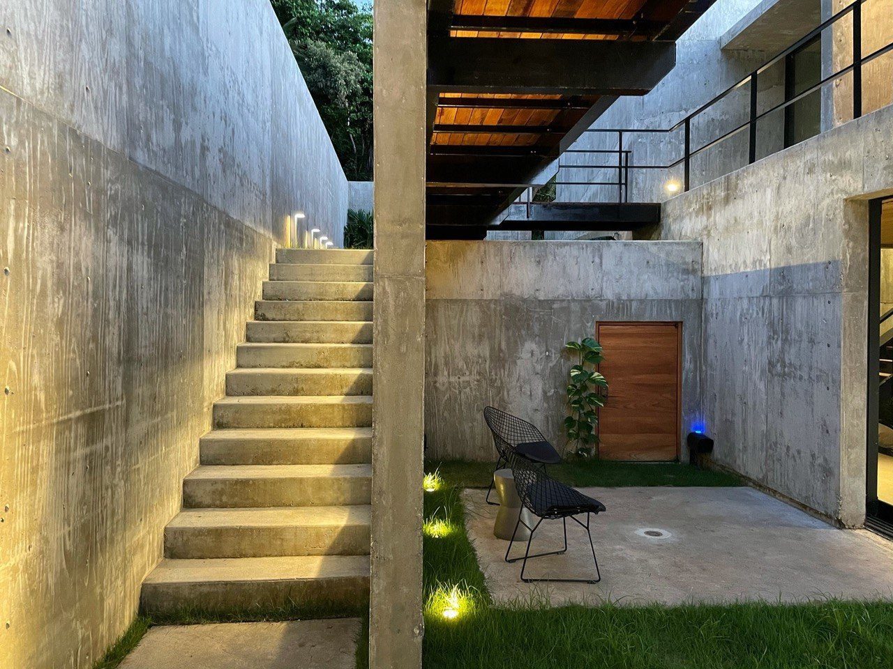 Lower courtyard with concrete stairs and landscape lighting
